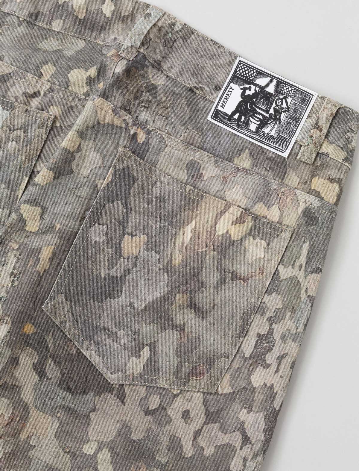 Camouflage-patterned fabric with a brand label on a white background