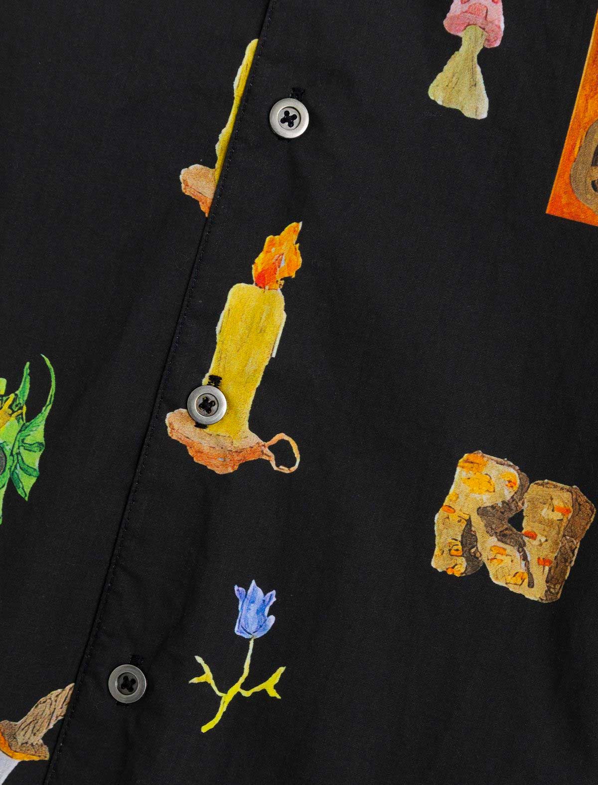 Black shirt with colorful embroidered designs of mushrooms and flowers on a black background.
