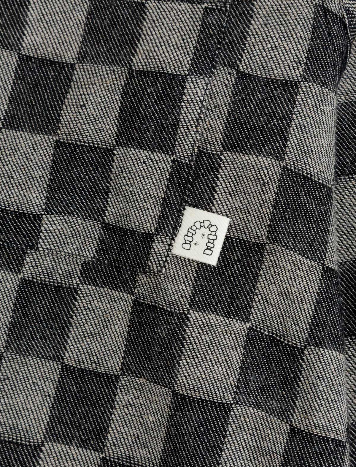 Checkered fabric with a small label featuring a cartoon character.