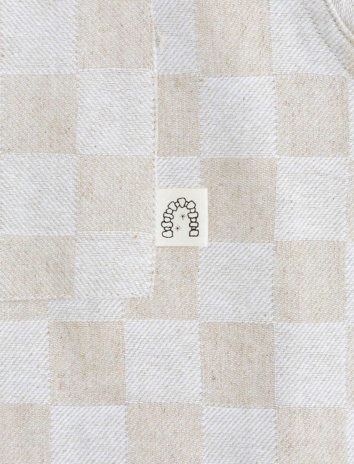 heresy arch logo on checked shirt pocket