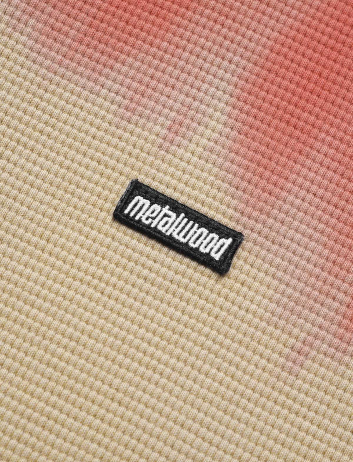 Close-up of a textured fabric surface with a 'metalwood' label.