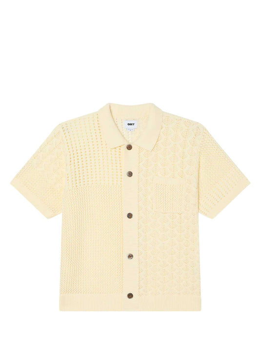Light yellow textured shirt with buttons on a white background