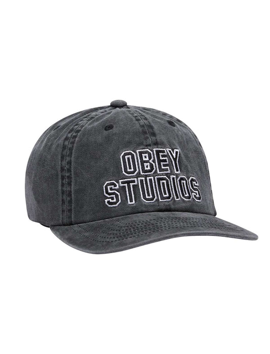 A baseball cap featuring an embroidered Obey Stusios graphic on the front, set against a plain white background.