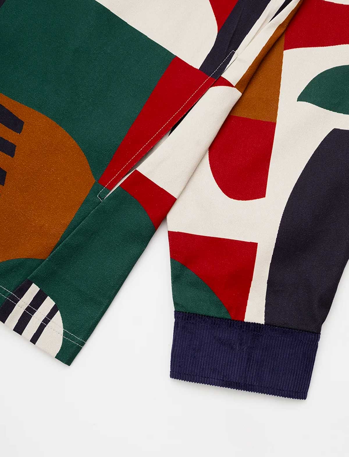 Close-up of the Parlez Bolt Jacket in Multi's sleeve cuff, showing the geometric print fabric and contrasting navy corduroy button cuff trim.