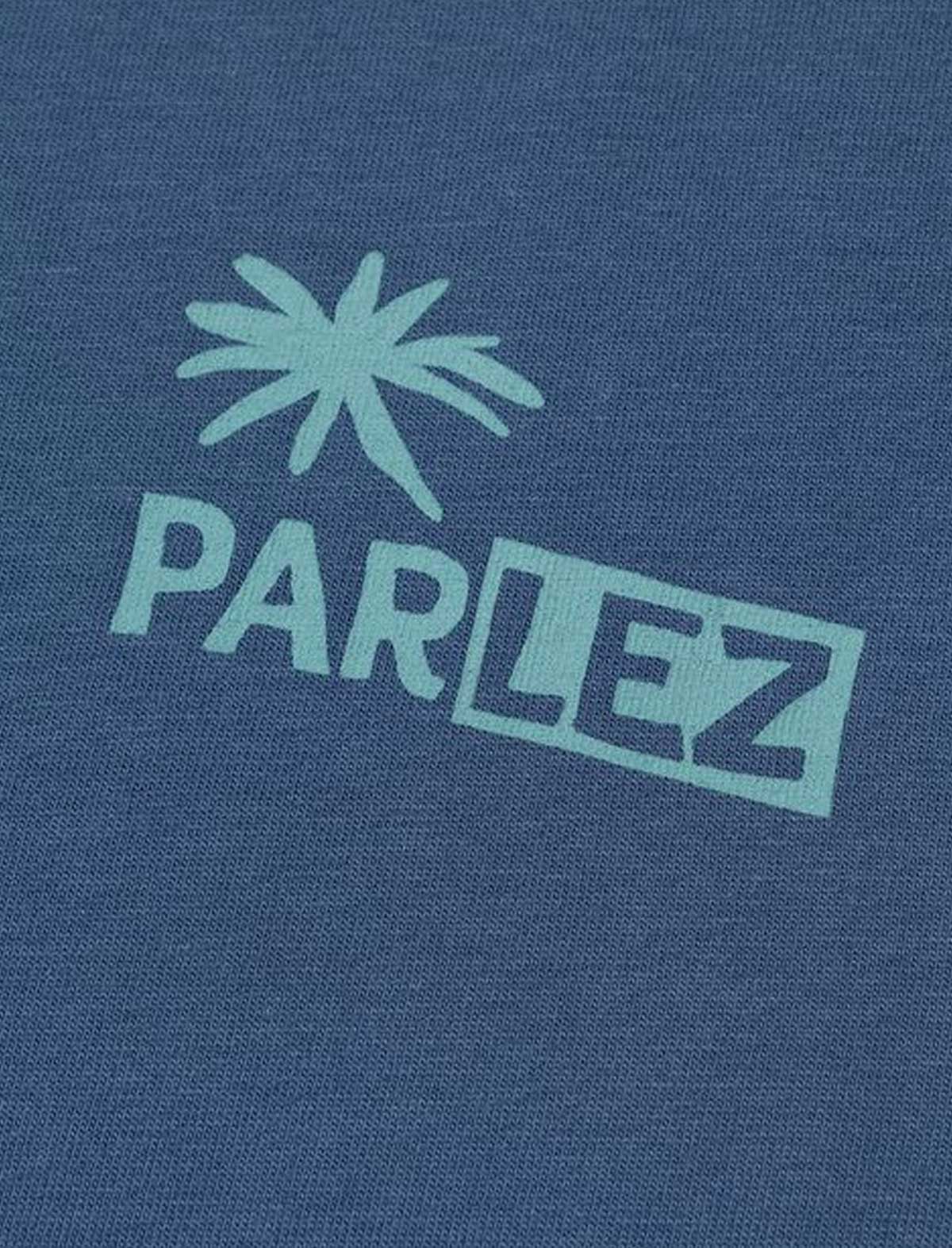 Close-up of a blue t-shirt with 'Parlez' logo on a blue background