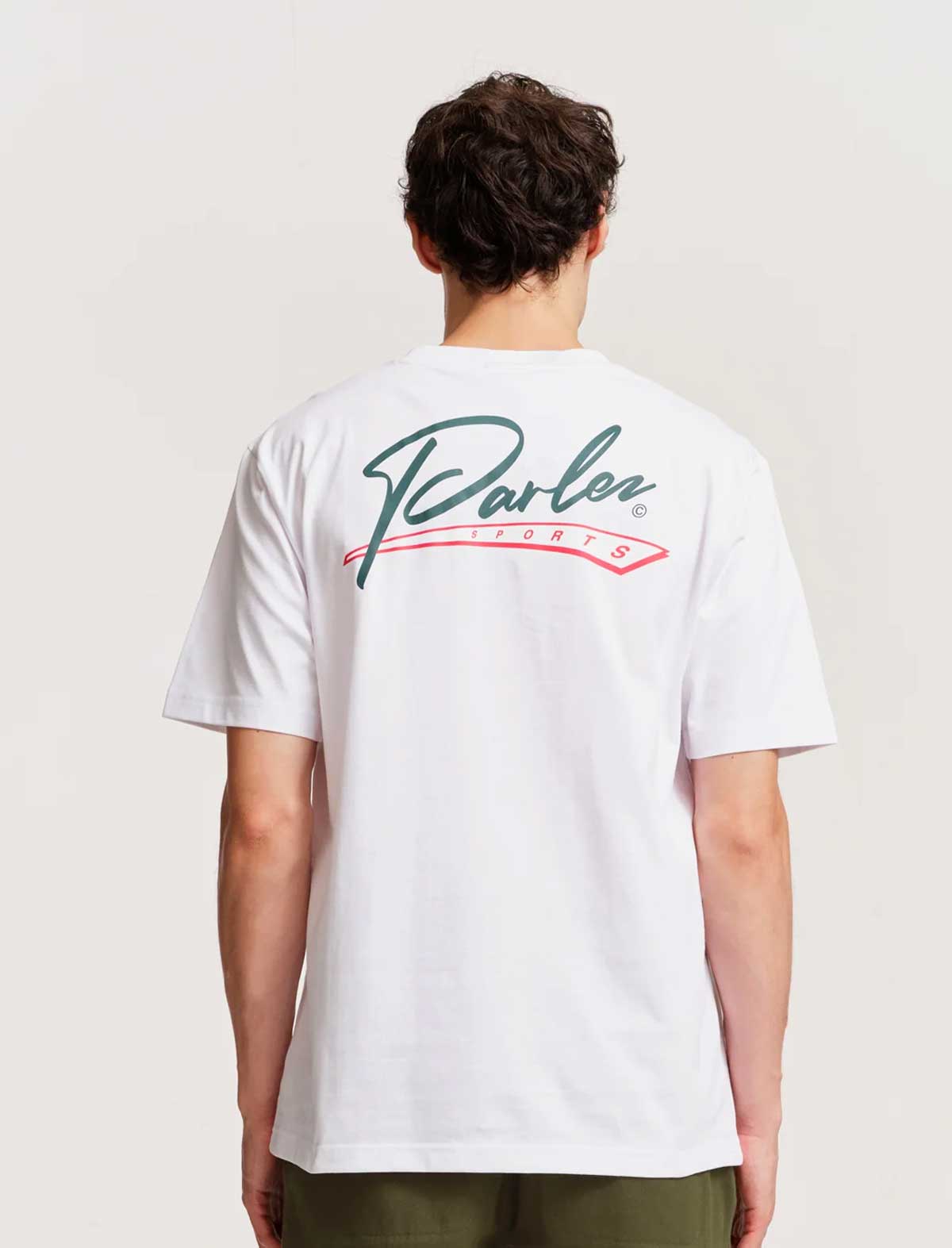 Person wearing a parlez inning white t-shirt with a logo on the back against a plain background