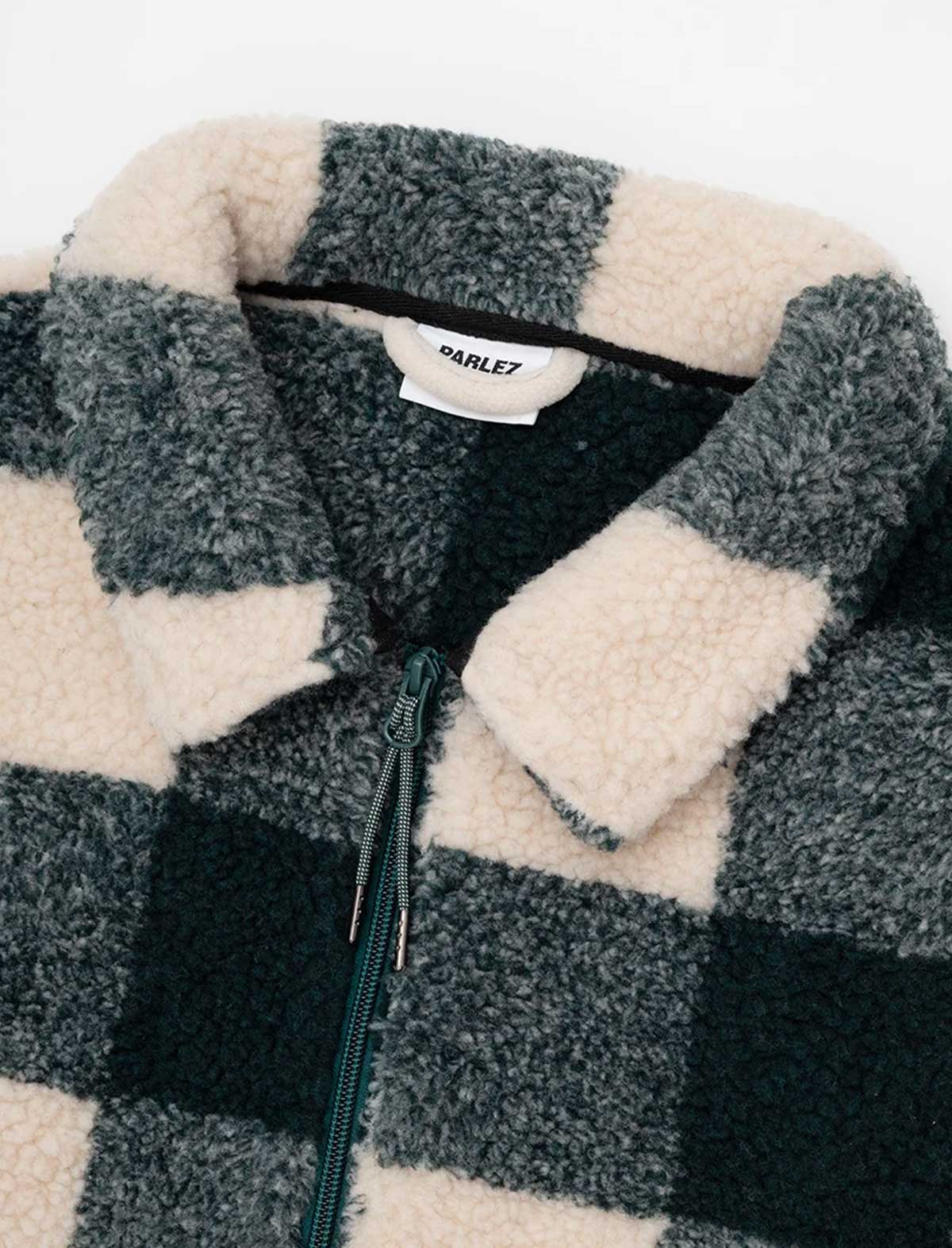 Close-up of the Parlez Province Check Sherpa Fleece Jacket in Deep Green's collar, showing the plush grey high-pile sherpa fleece against the green and cream check body fabric.