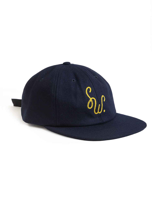 A navy blue flat-brim baseball cap with a yellow embroidered cursive 'SW.' logo on the front, shown against a plain white background.