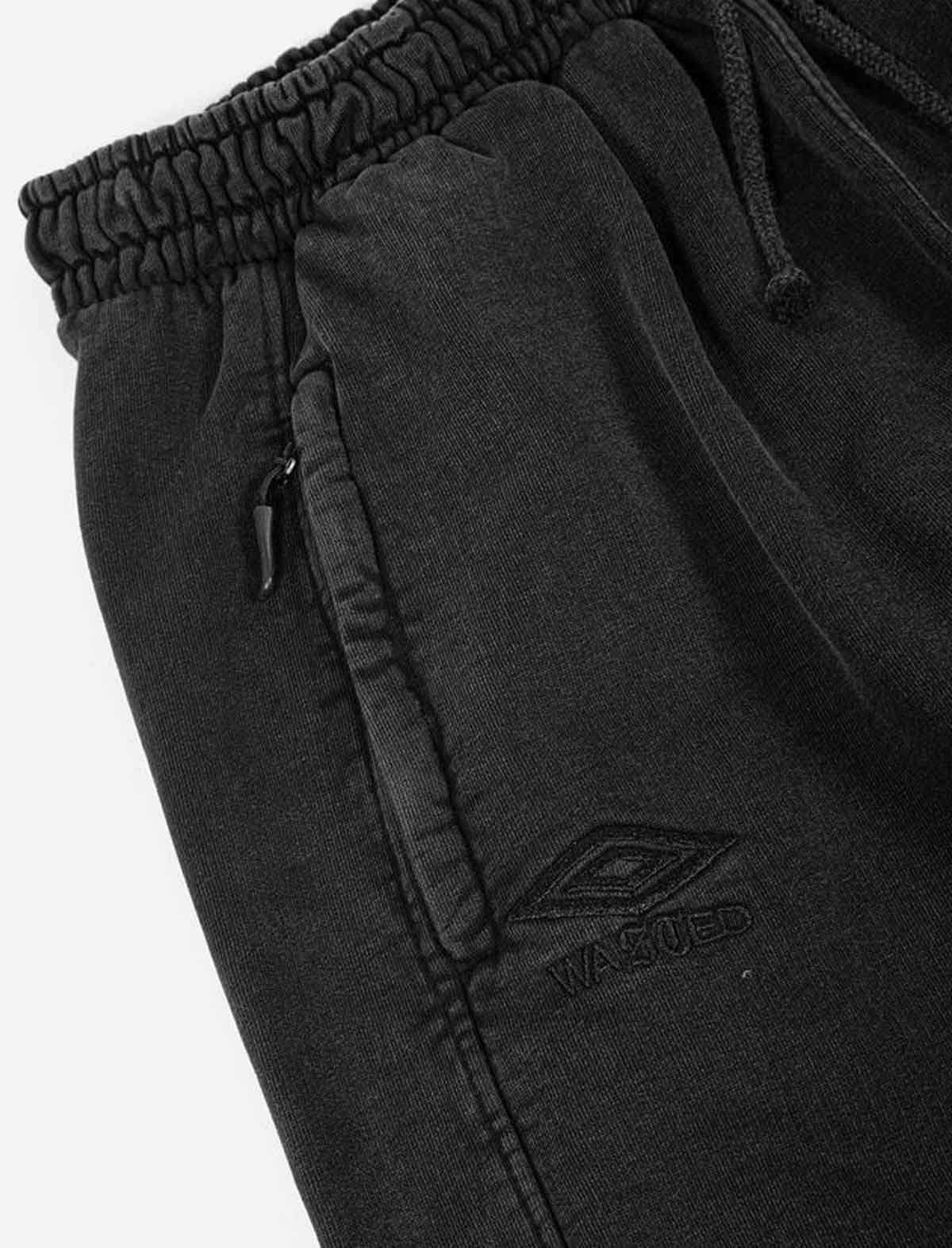 Wasted Paris x Umbro Black jogger pants with a brand logo on a white background