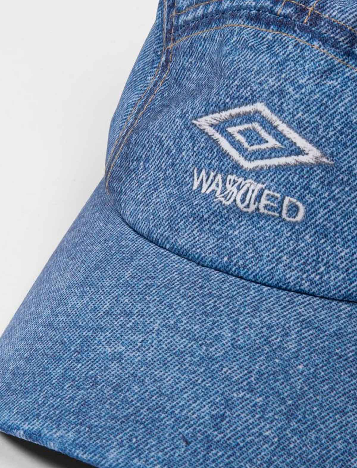 Wasted Paris x Umbro Trompe L'Oel Track Blue denim cap with embroidered logo on a white background
